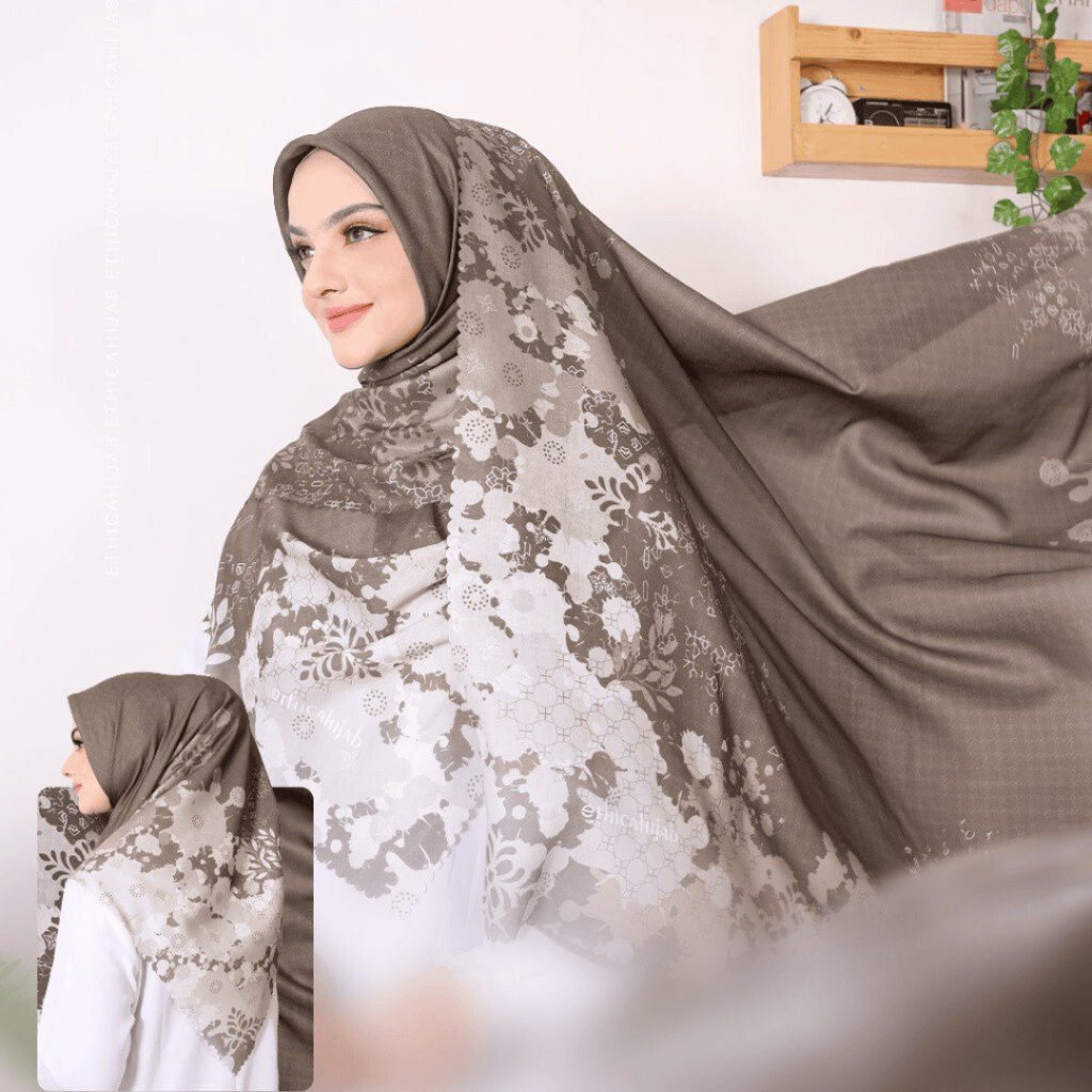 Hijab bermotif abstrak dipadukan dengan gamis polos warna pastel.